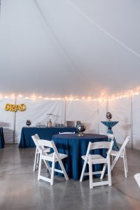 Tables for guest seating and linens for grad party